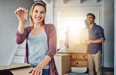 Happy couple holding a key in a hand
