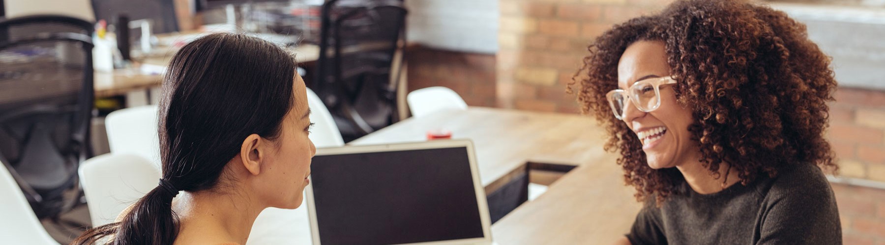 Two women having a conversation and smiling